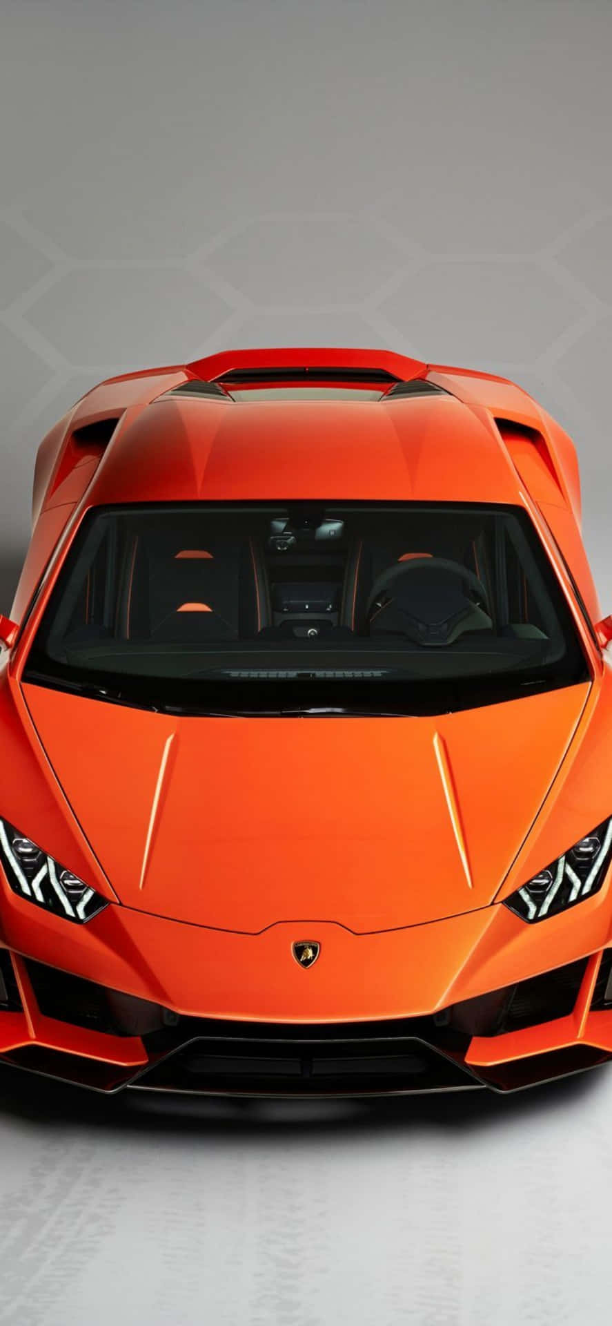 Download The Front Of An Orange Sports Car | Wallpapers.com