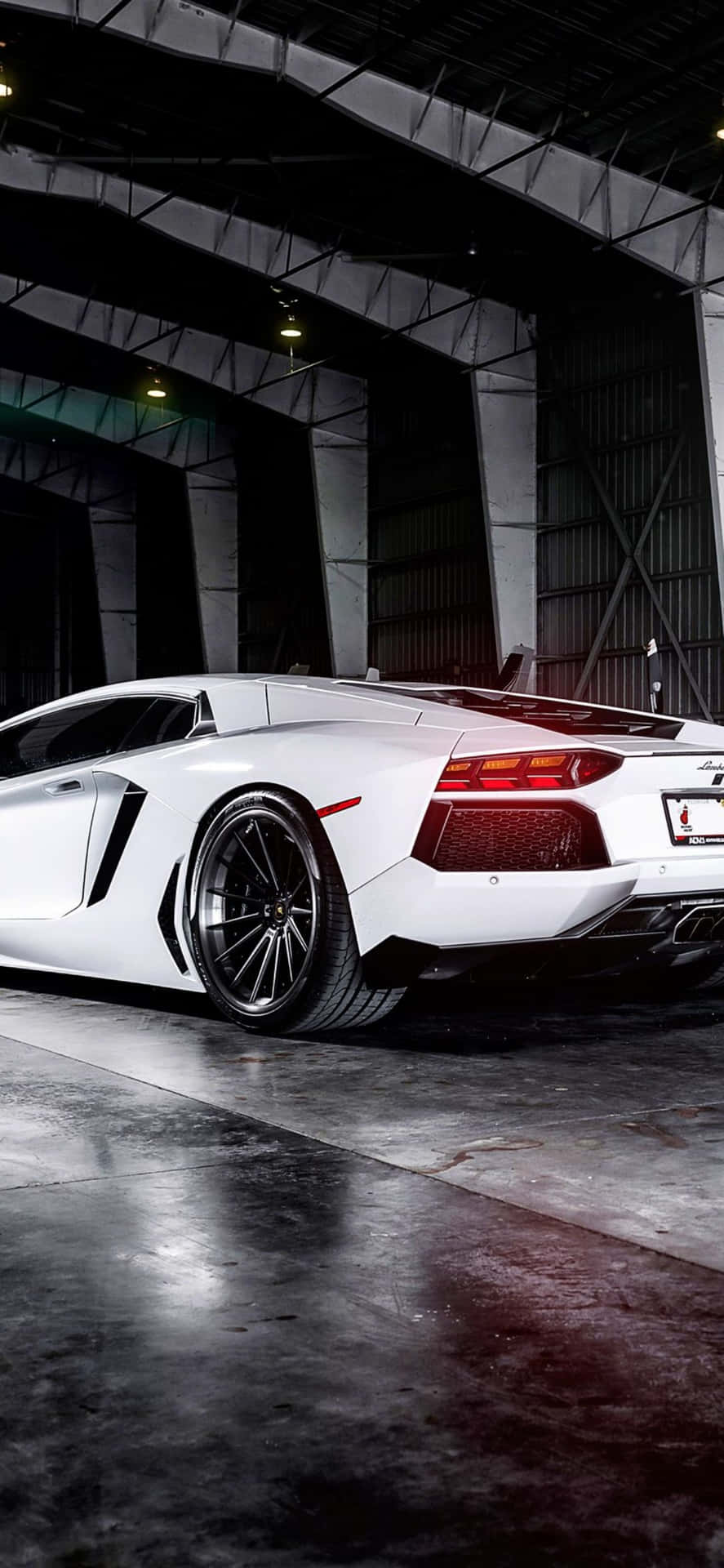 A White Lamborghini Parked In A Garage