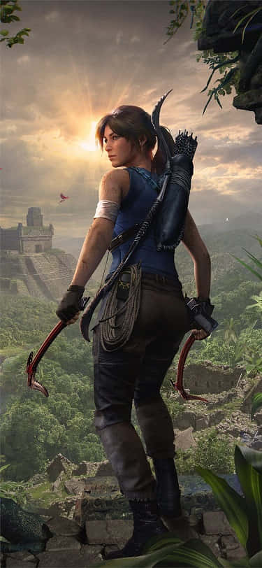 the tomb raider is standing on a cliff with a bow