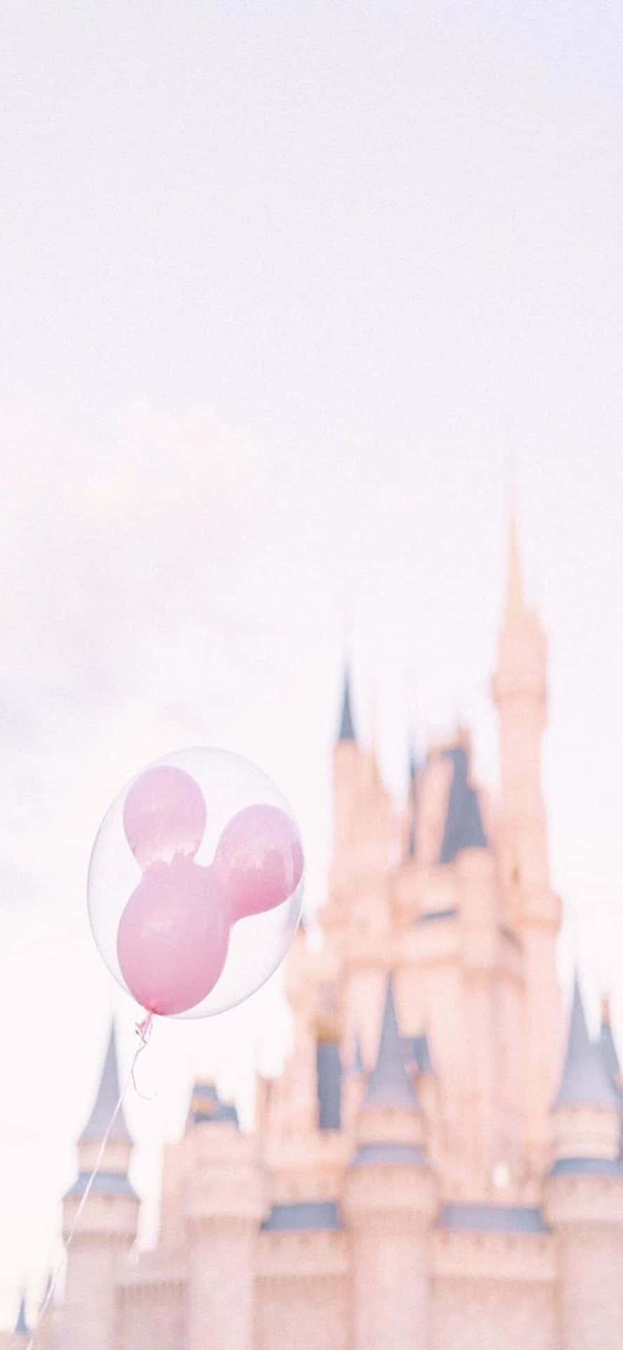 A Pink Balloon Is In Front Of A Castle