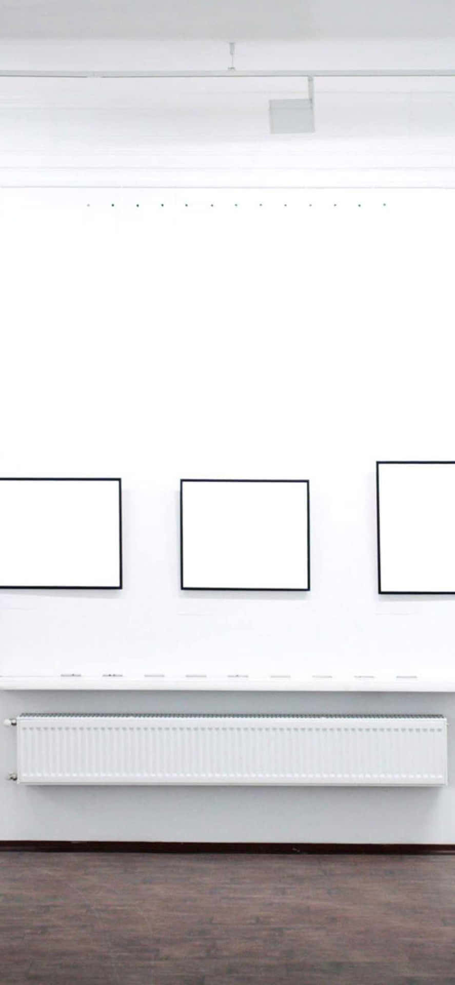 A White Room With Several Blank Framed Pictures