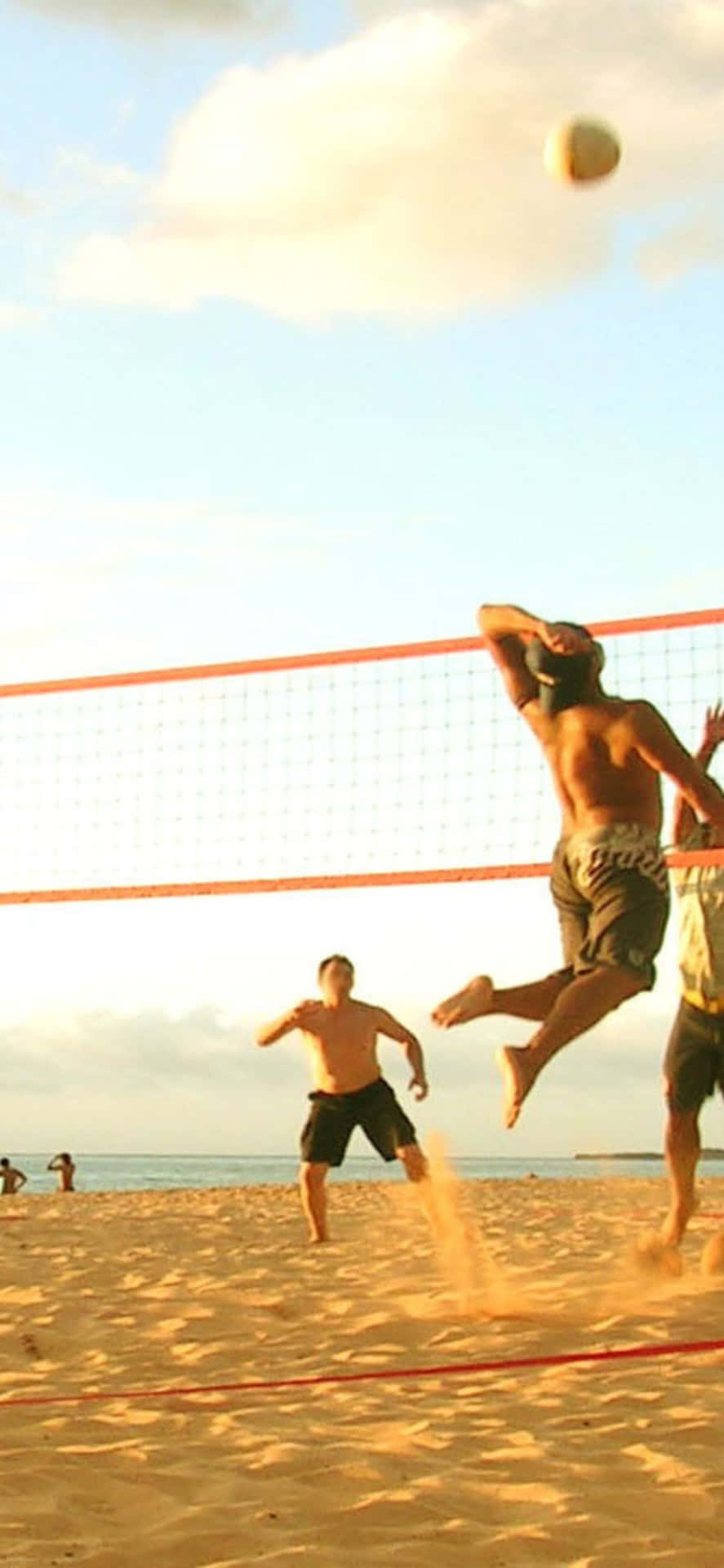 A Group Of People Playing Volleyball