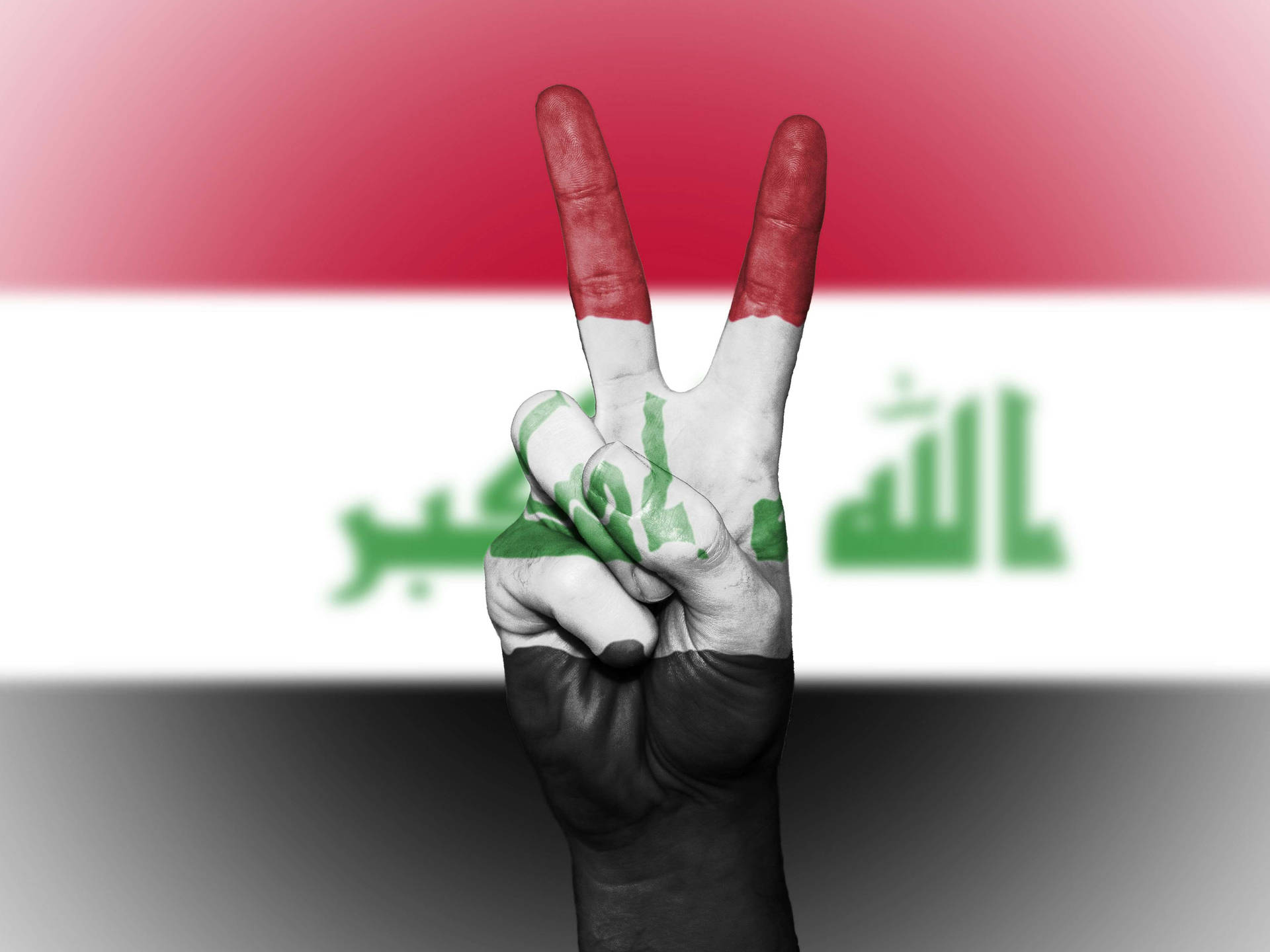 The Peaceful Power of Iraq - A hand symbolizing peace covered with an Iraqi flag. Wallpaper