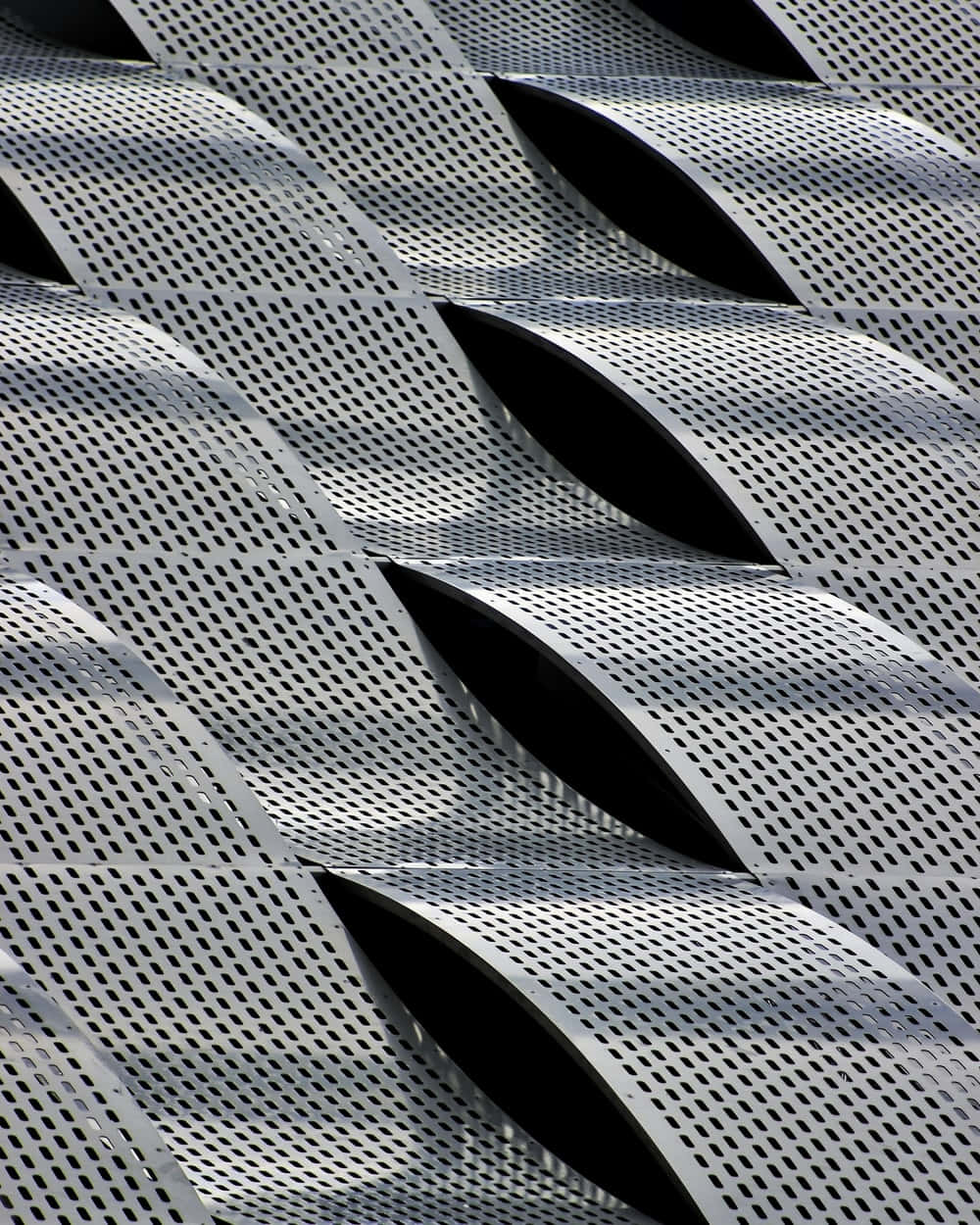 A Close Up Of A Metal Building With A Pattern