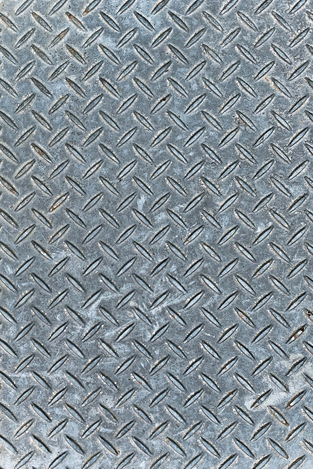 A Close Up Of A Metal Diamond Plate
