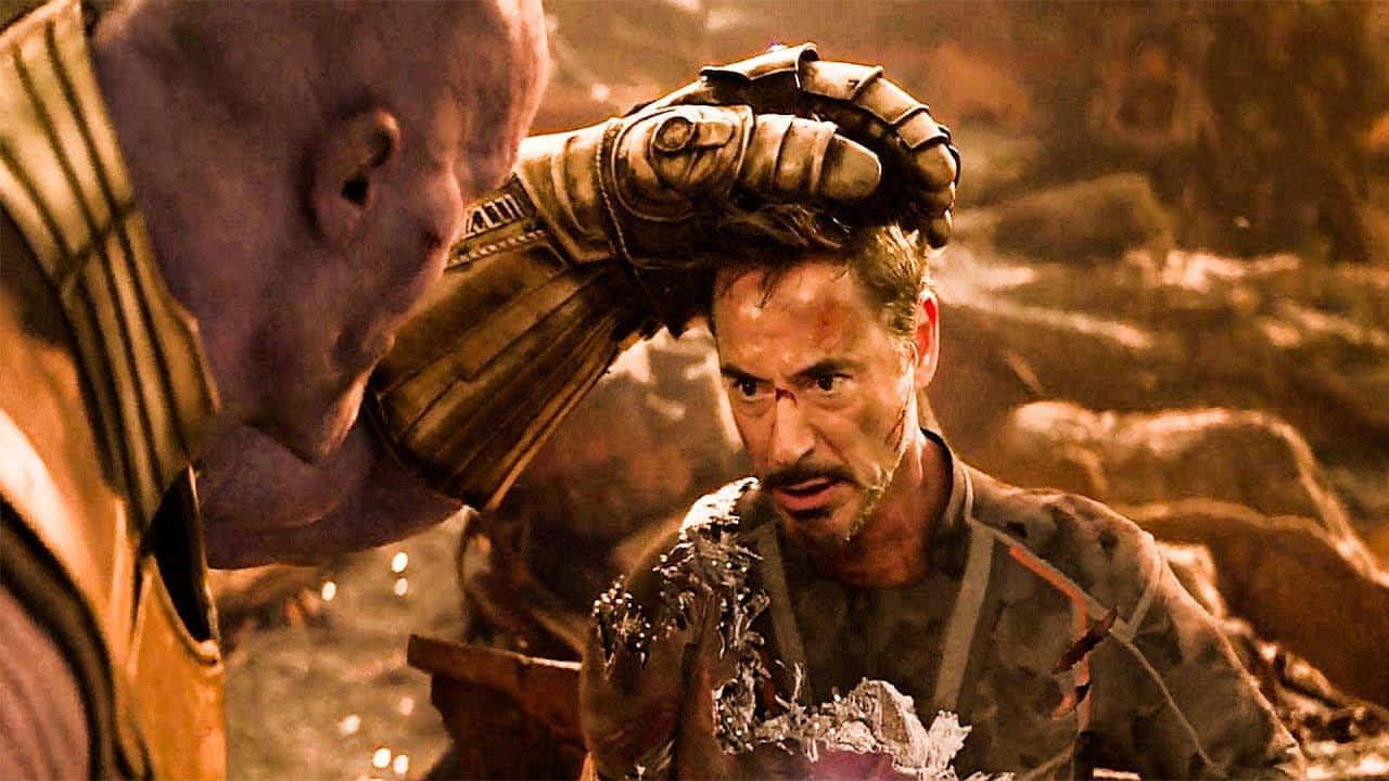 Iron Man Facing Off Against Thanos Wallpaper