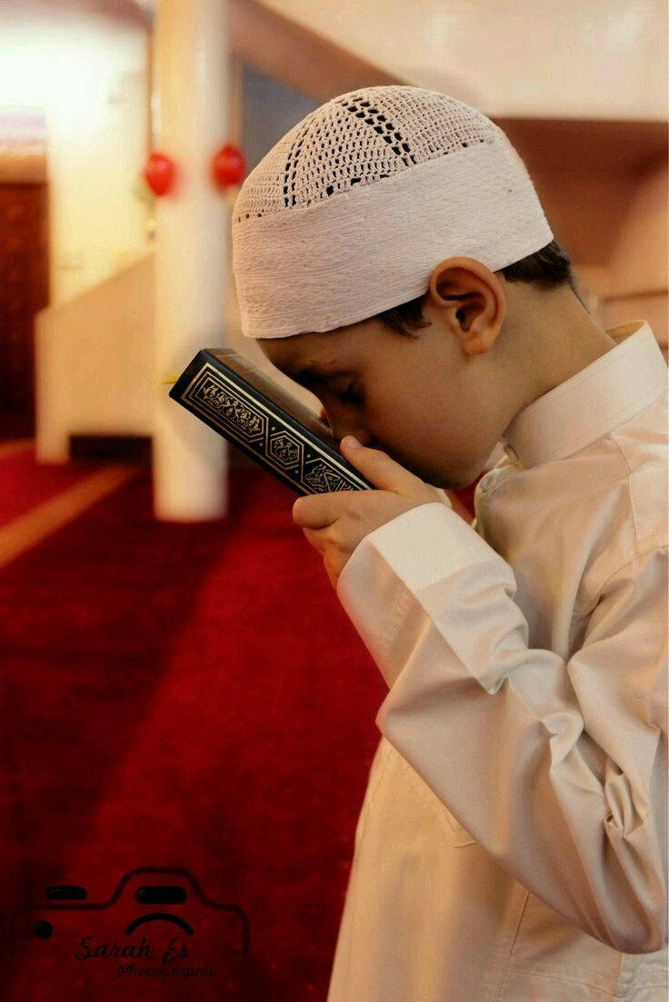 Islamic Boy Kissing Quran Picture