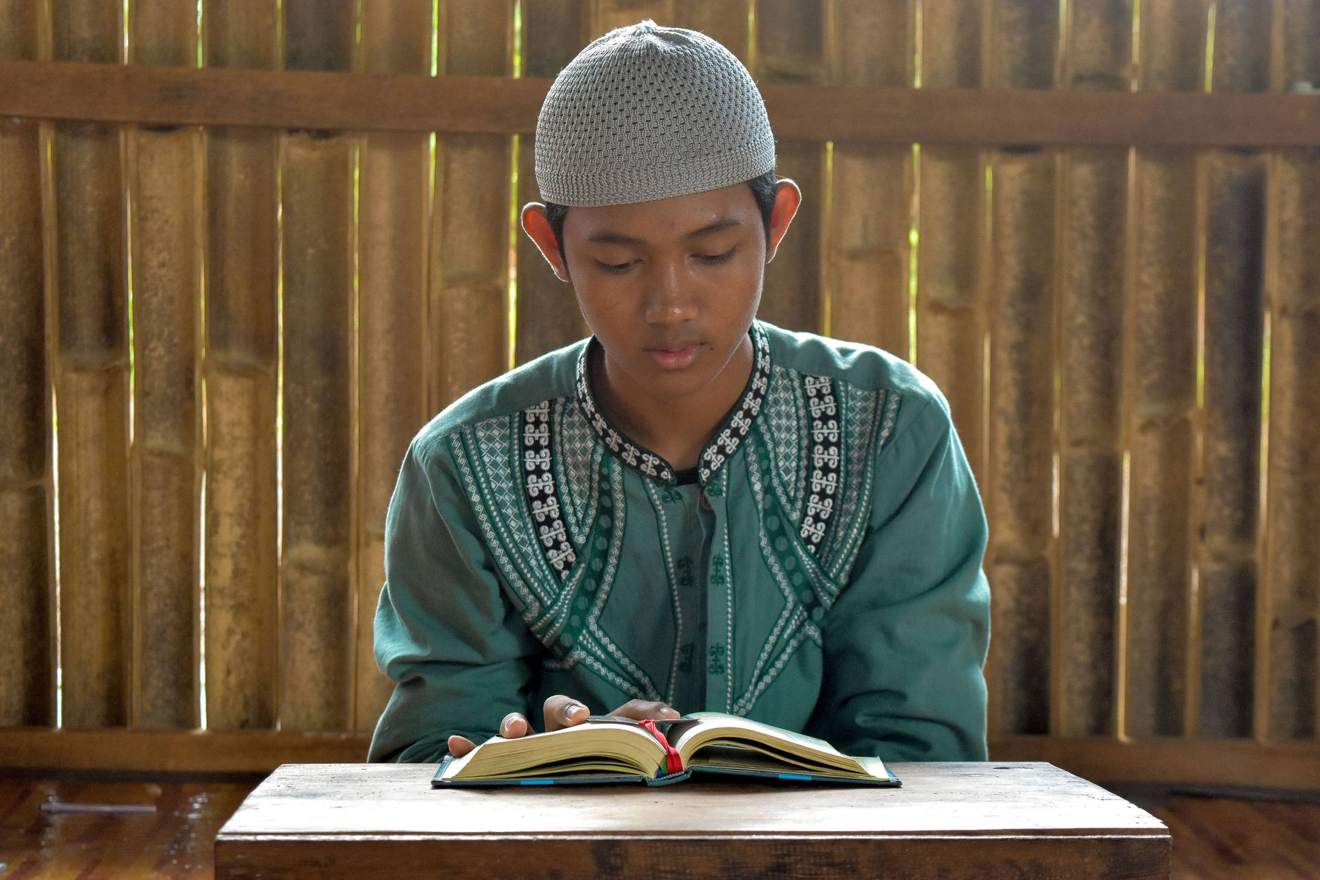 Islamic Boy Reading Quran Indoors Background