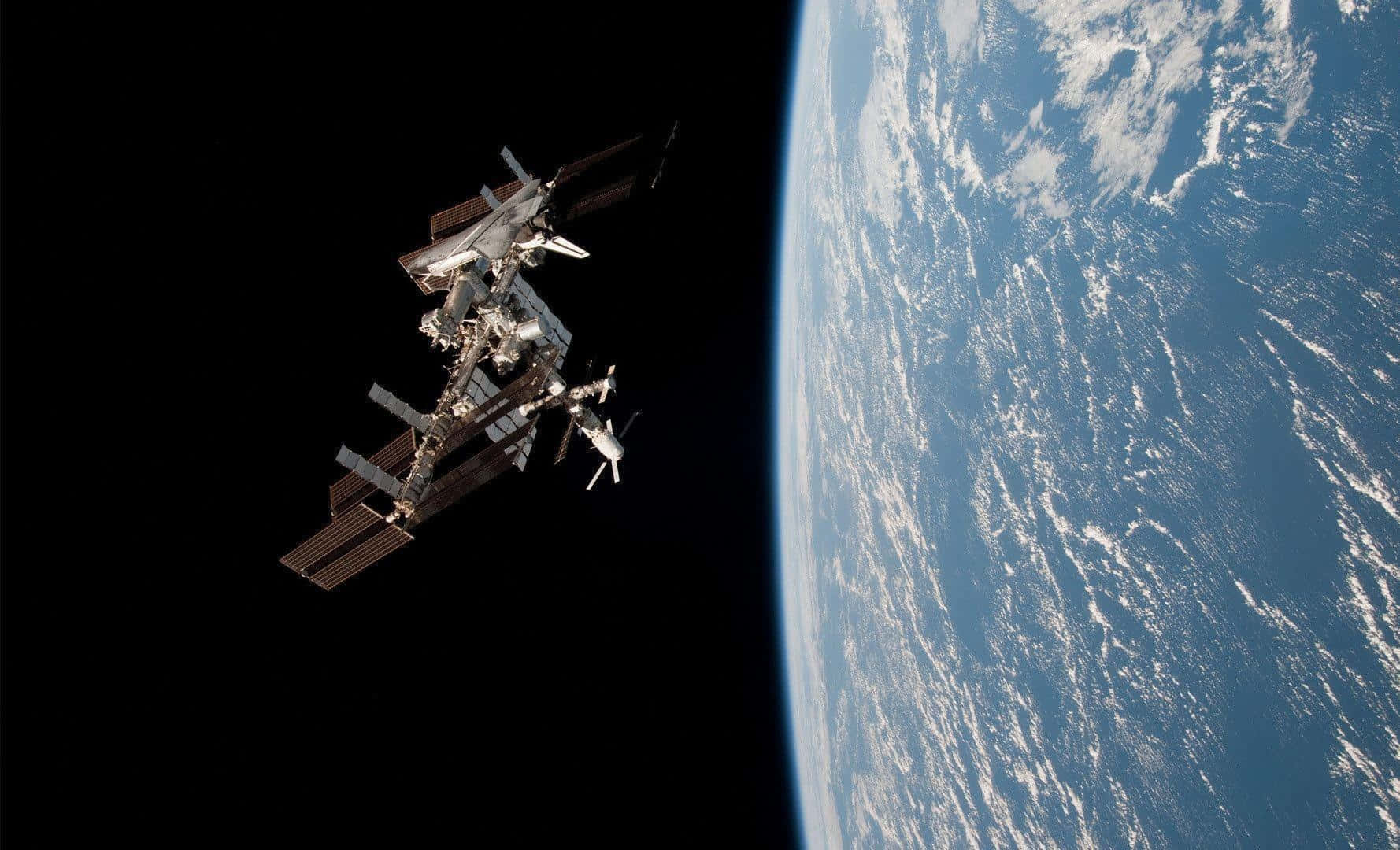 Stunning high-resolution view of the International Space Station orbiting Earth Wallpaper