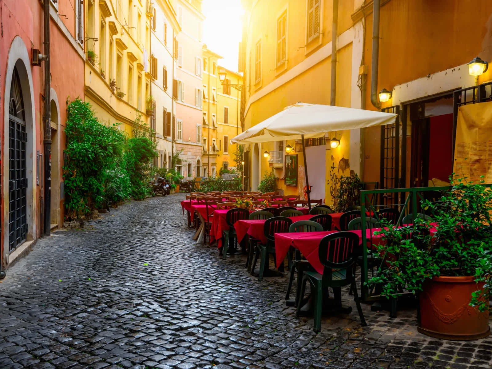 A Cobblestone Street With Tables And Chairs