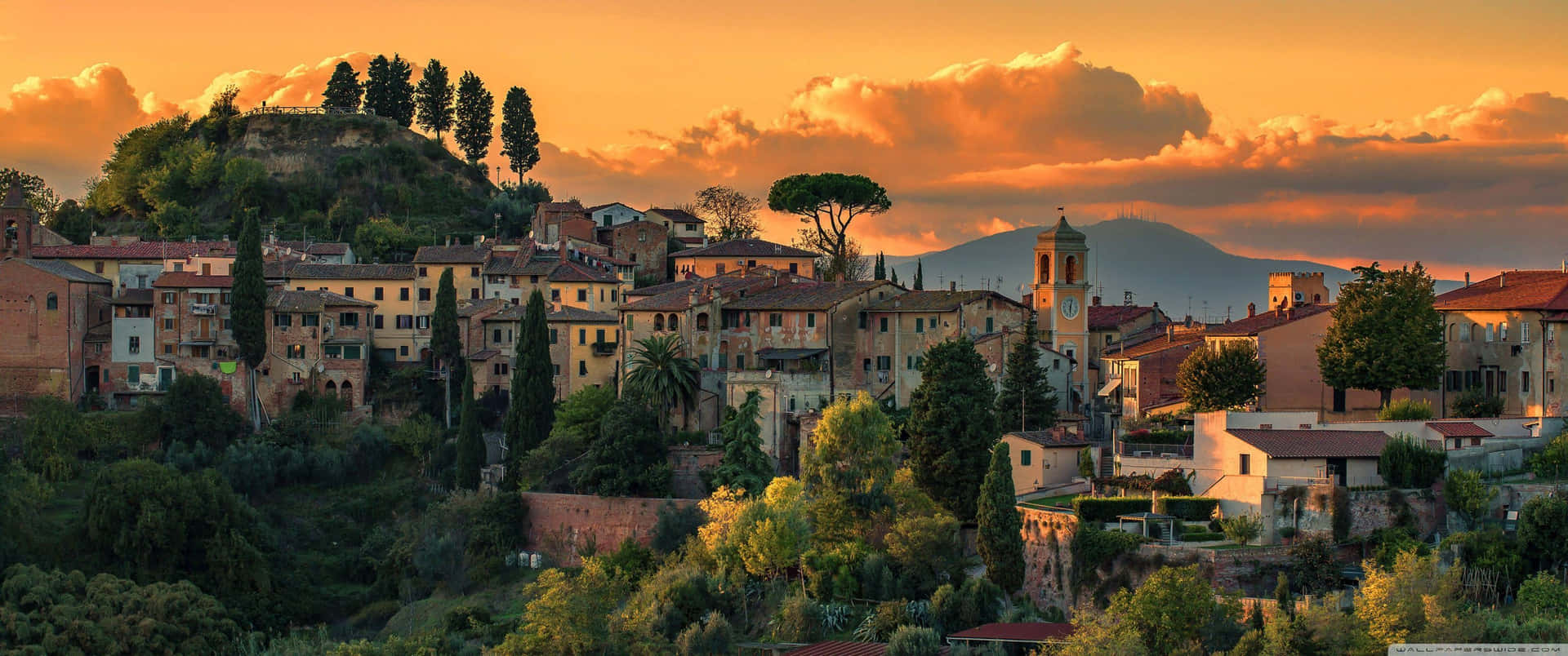 A Town Is Seen At Sunset In Italy Wallpaper