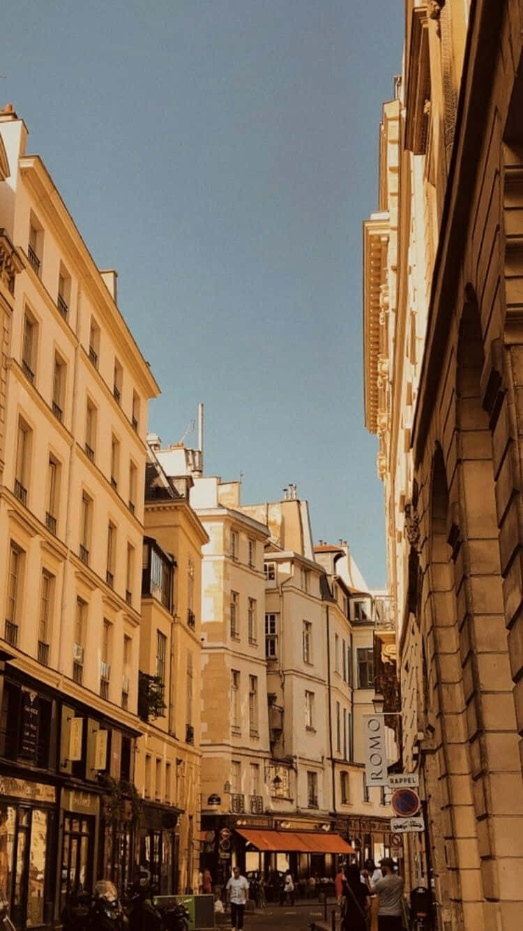 A Street In Paris With Many Buildings And People Wallpaper