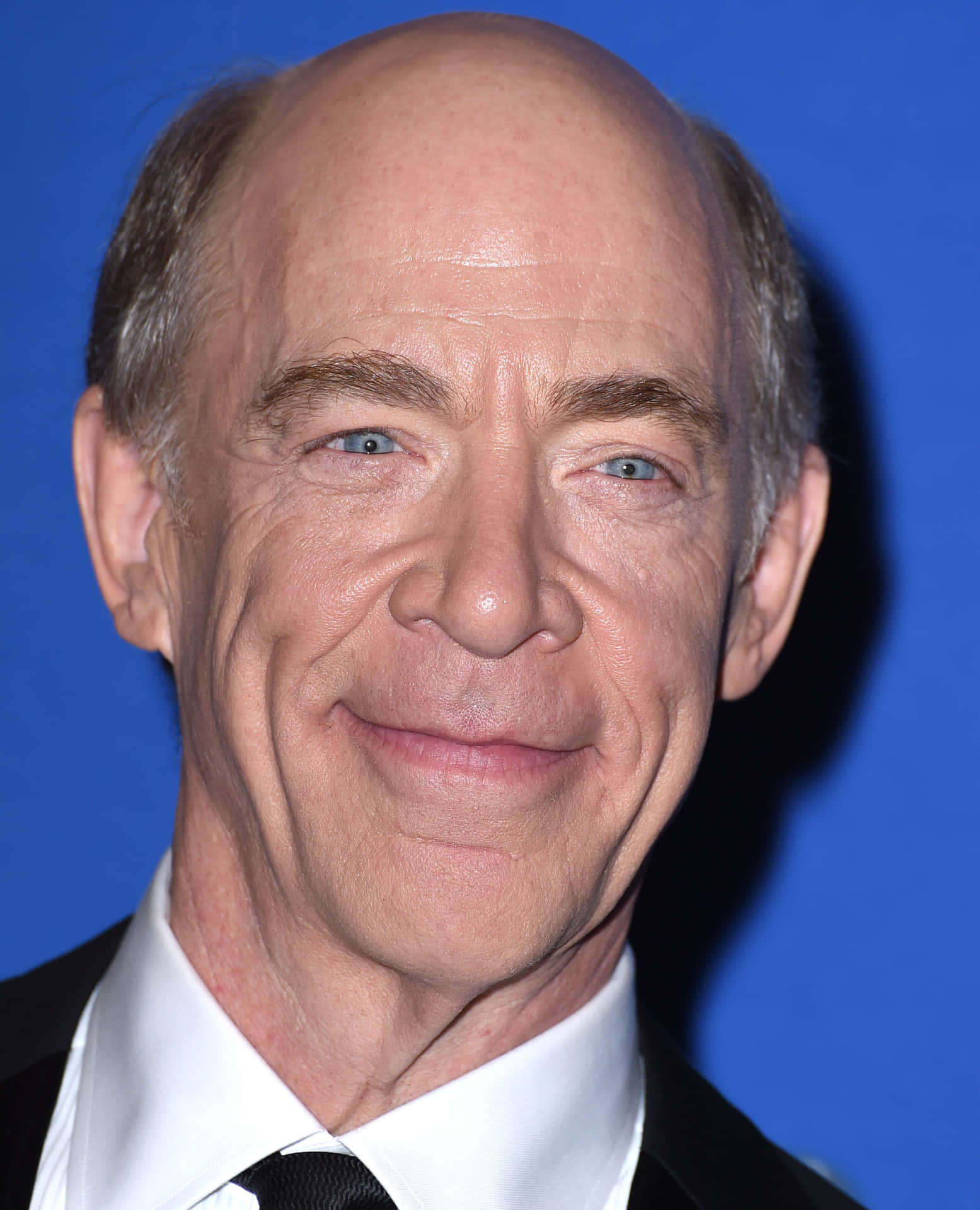 Established actor J.K. Simmons in a thoughtful portrait Wallpaper