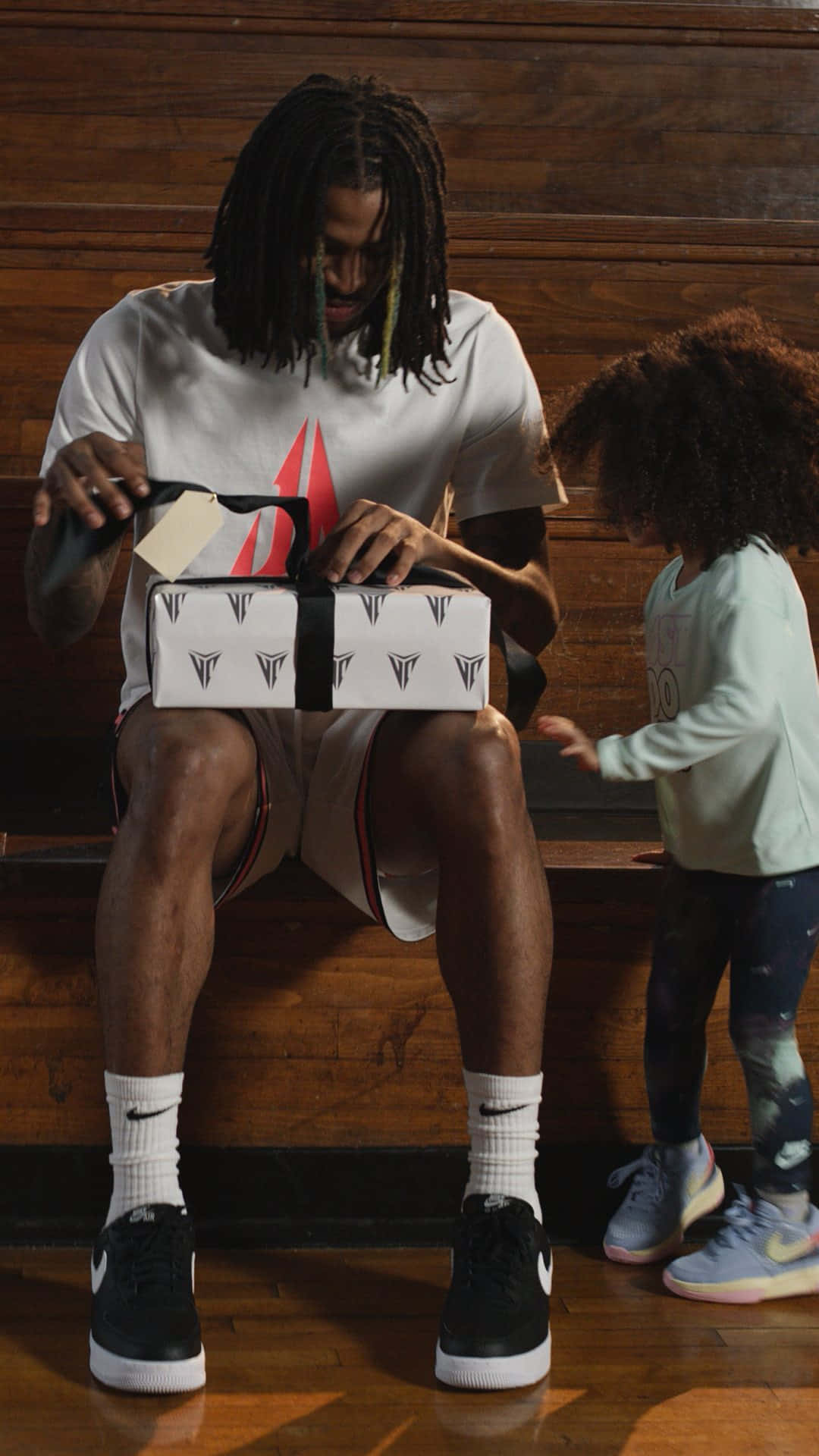 Ja Morrant Unboxing A Package With His Daughter Wallpaper