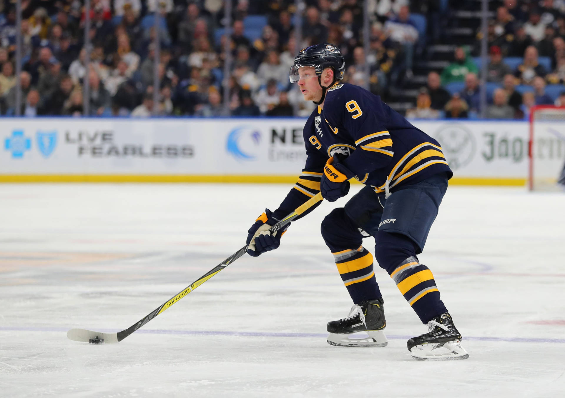 Jack Eichel, Star Player of Buffalo Sabres, skillfully handling the puck Wallpaper