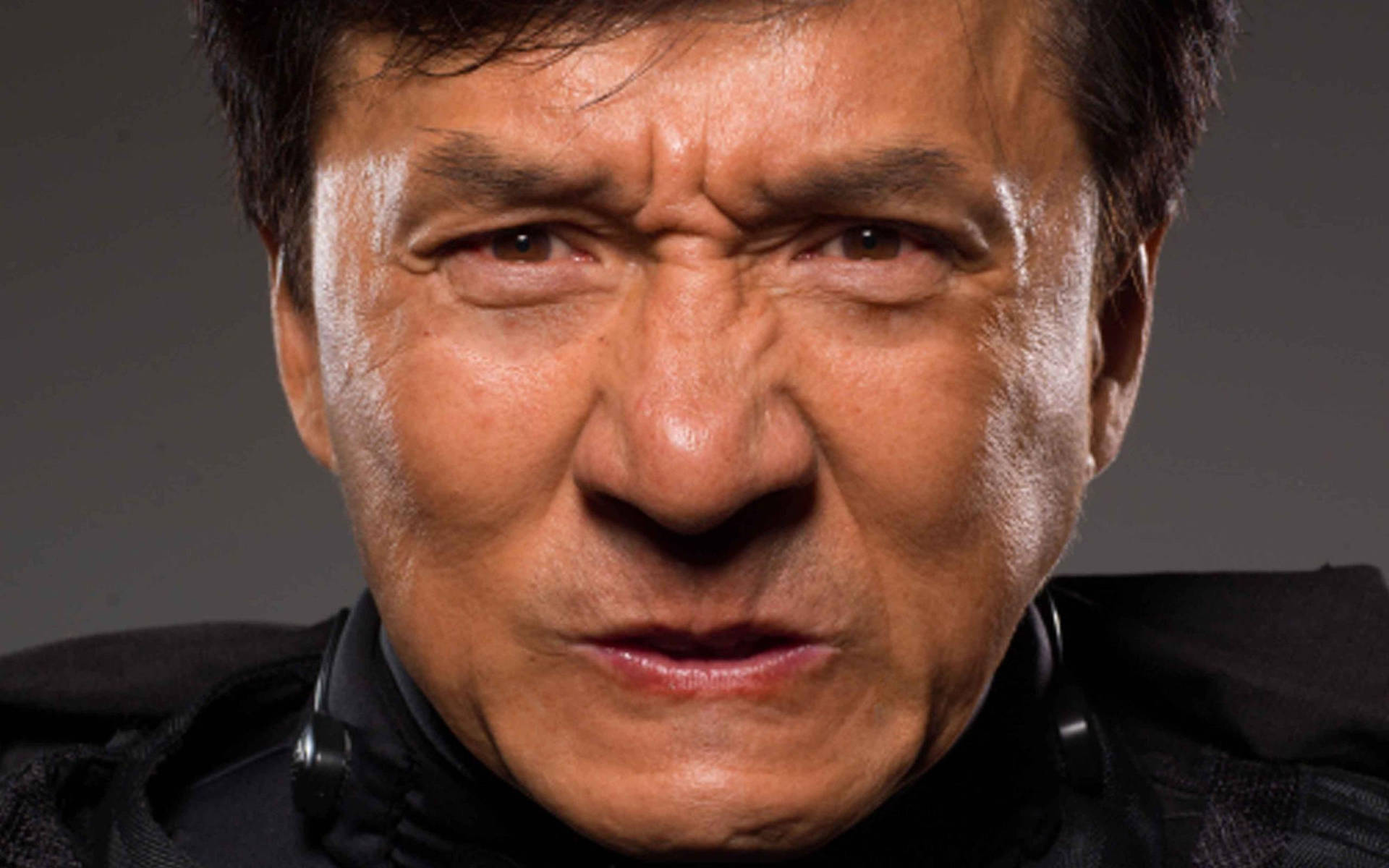 Jackie Chan Intense Face Background