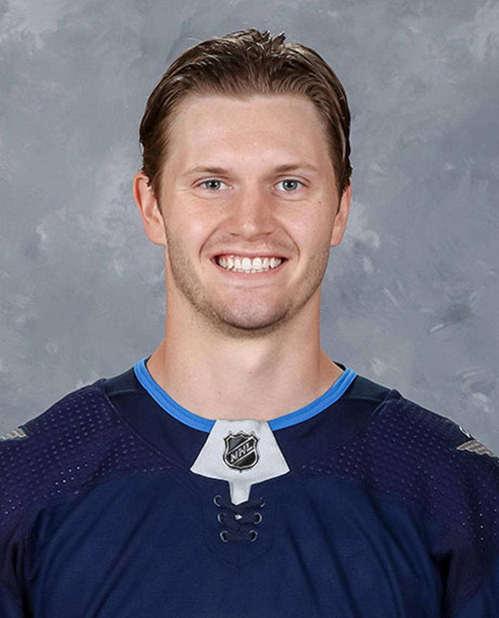 Jacob Trouba Smiling For The Camera Wearing Blue Jersey Wallpaper
