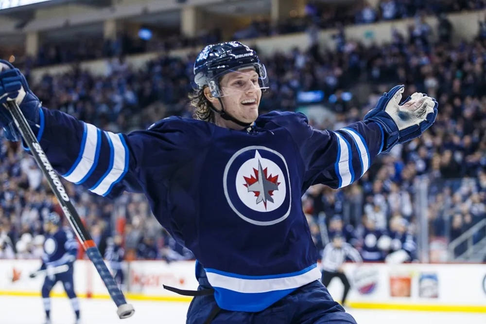 Jacob Trouba Smiling With Hands Open Wide During Game Wallpaper