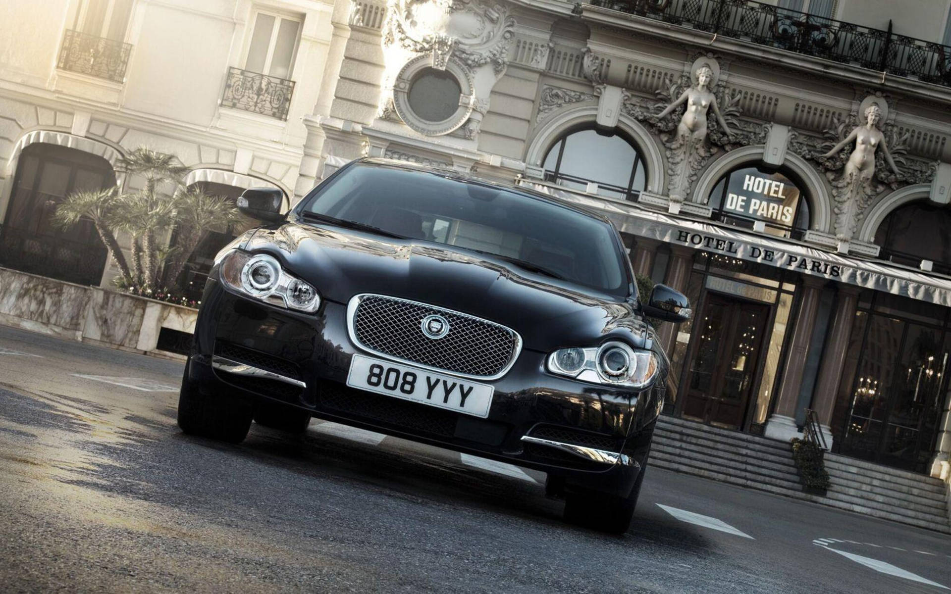 Luxury on Display: Jaguar Car at the Iconic Hotel de Paris Wallpaper