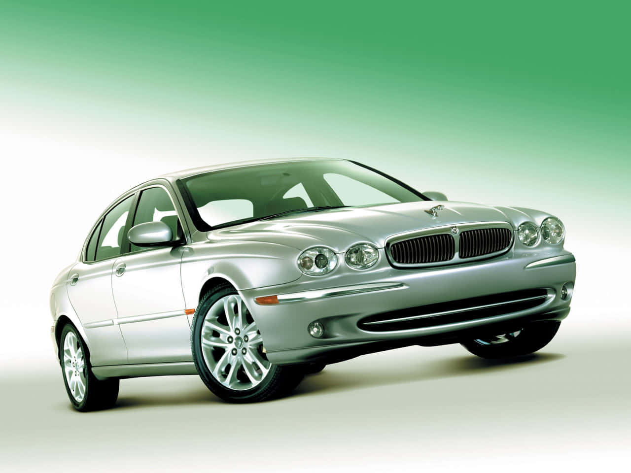 Elegant Jaguar X-Type in motion on city streets Wallpaper