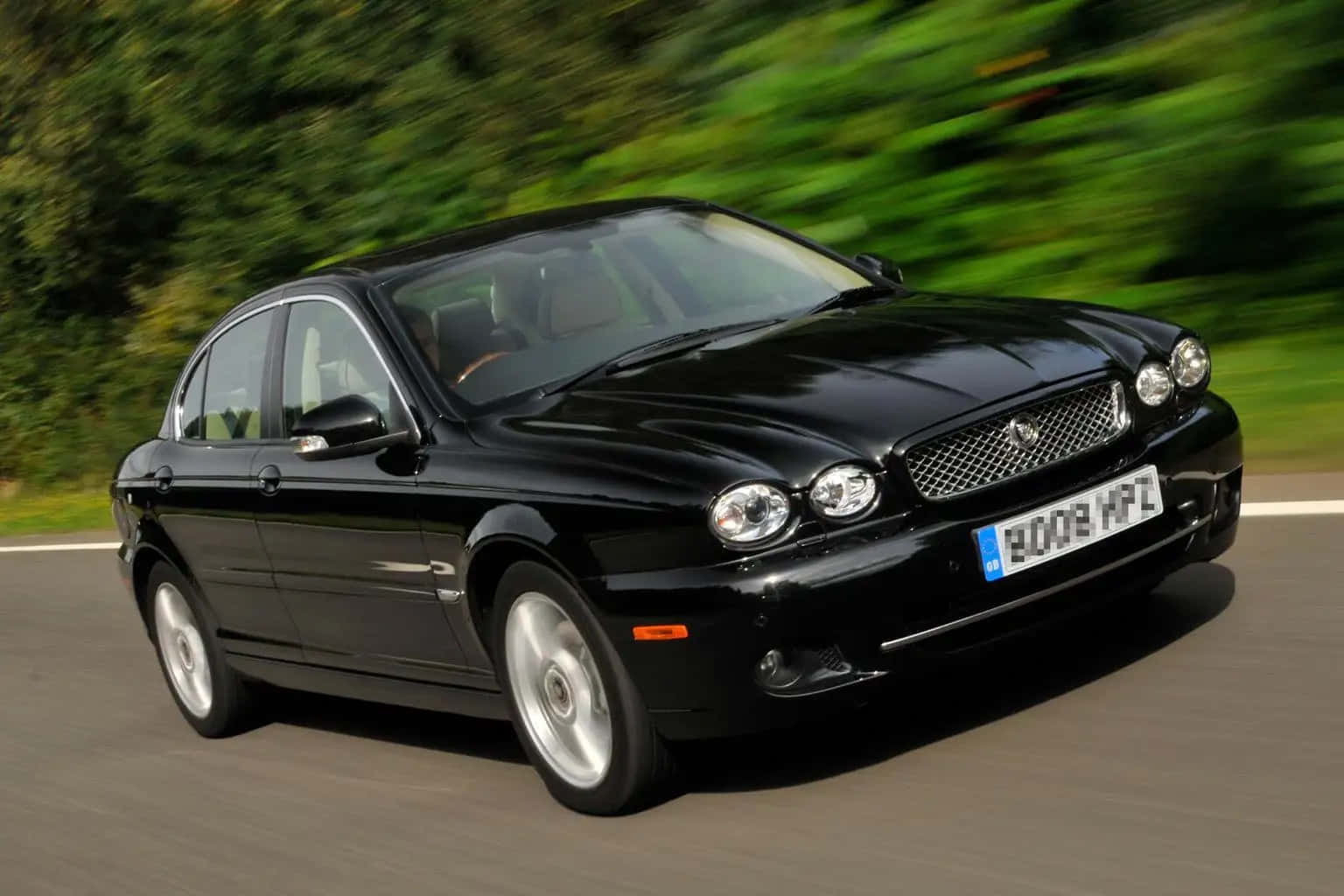 Sleek and Stylish Jaguar X-Type in Action Wallpaper