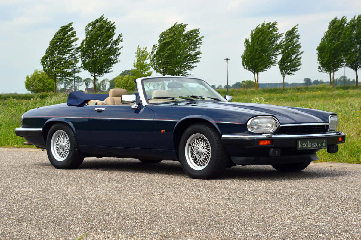 A Classic Red Jaguar XJS Sports Coupe on the Run Wallpaper