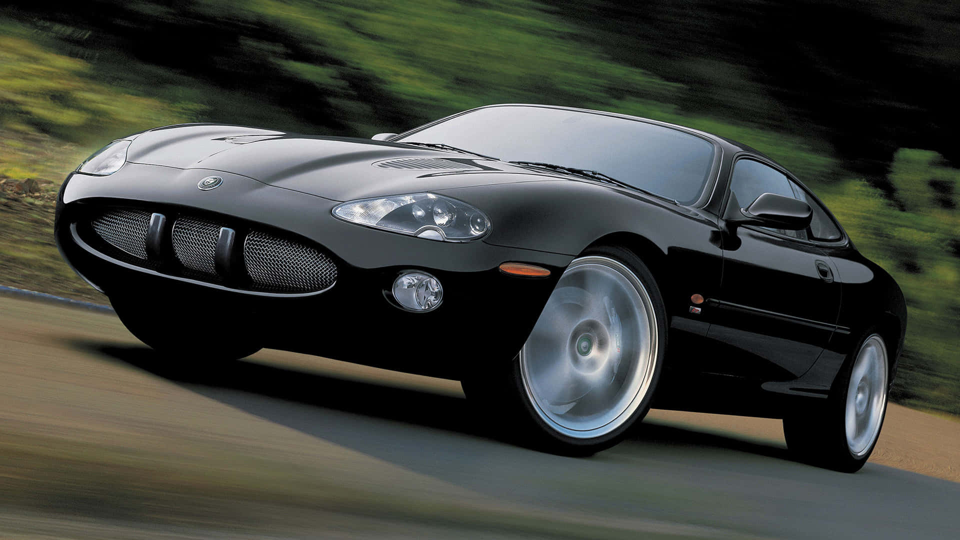 Sleek Jaguar XKR Roaring on the Road Wallpaper
