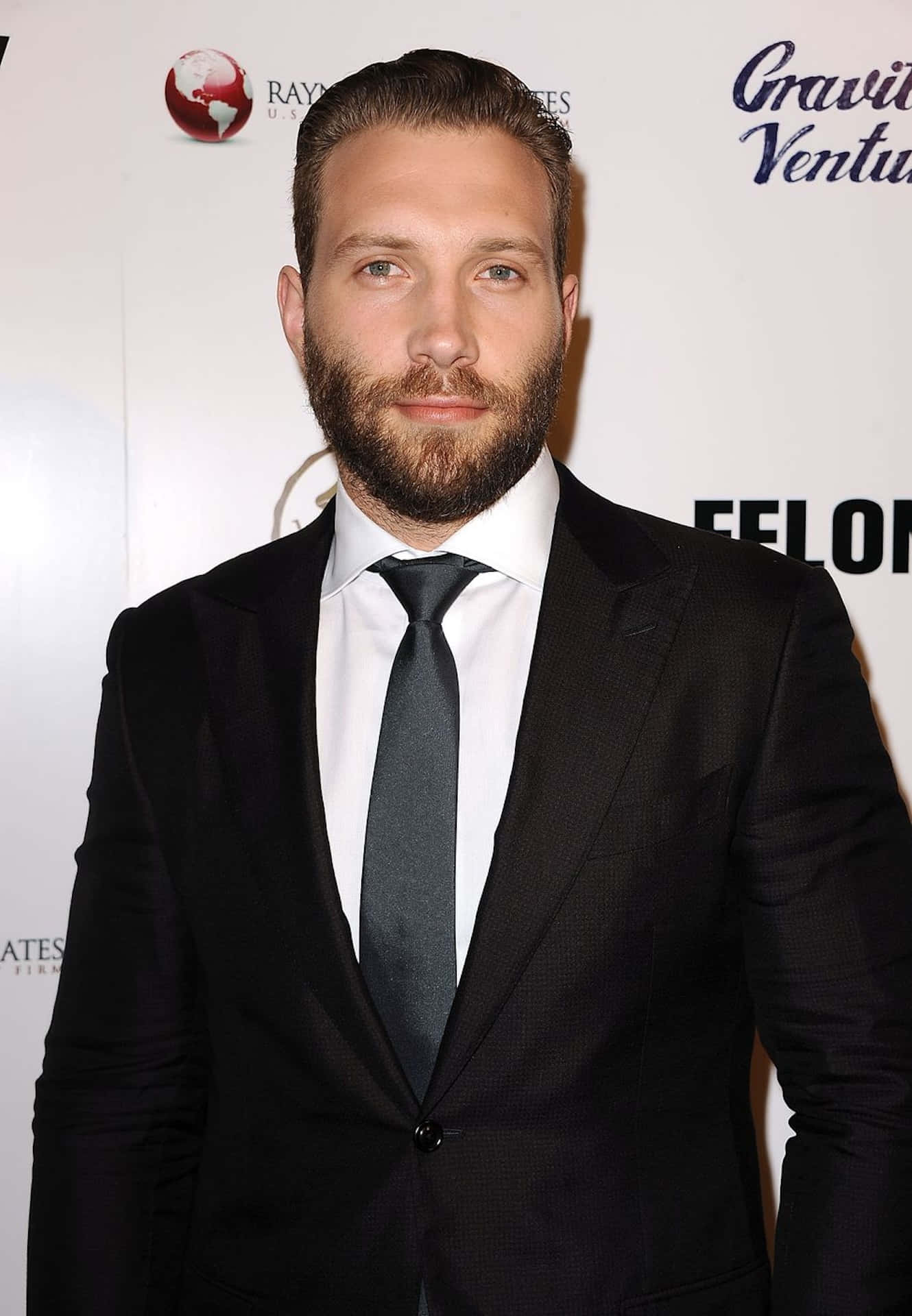 Download Jai Courtney Black Suit Event Wallpaper | Wallpapers.com