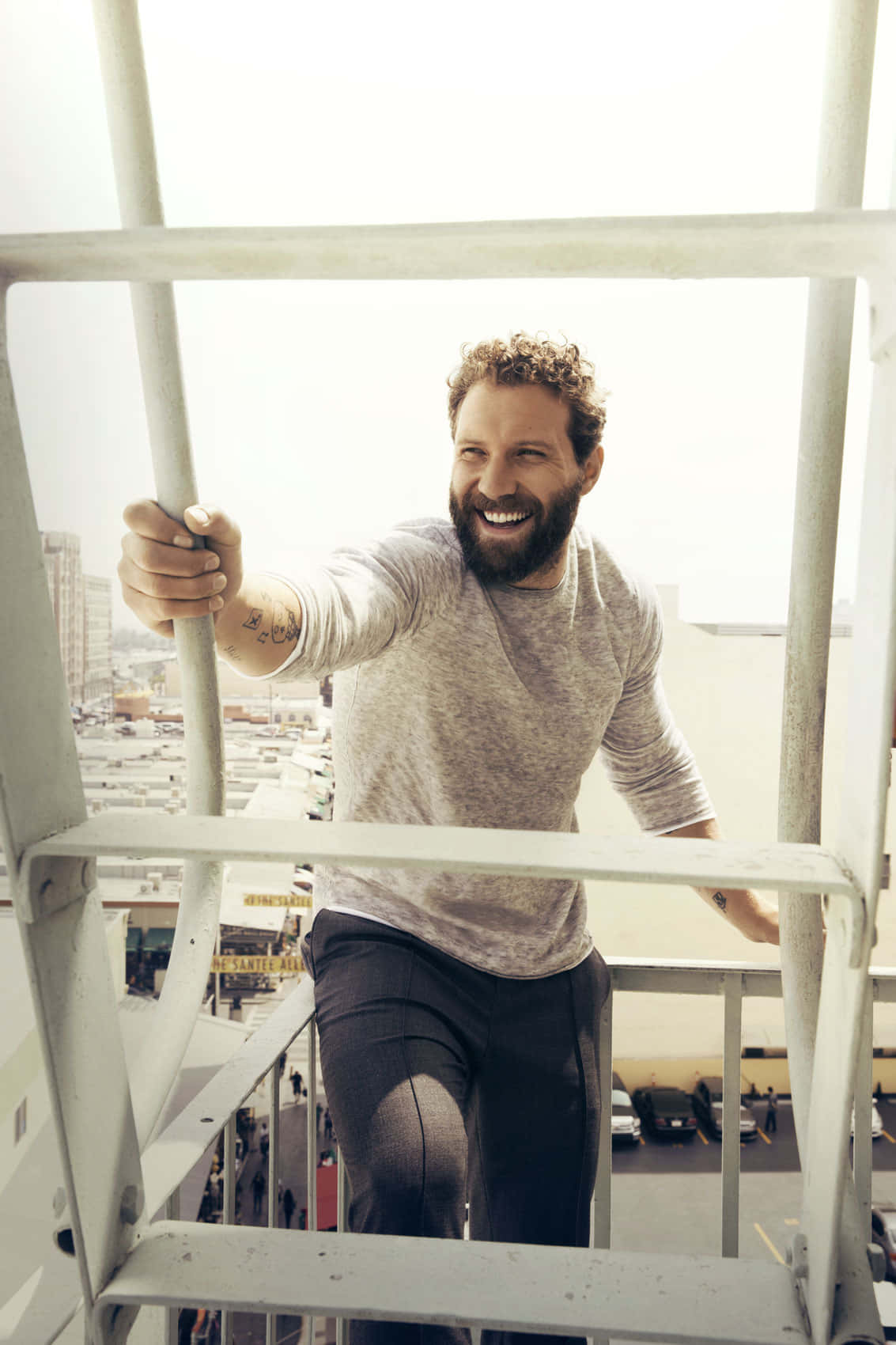 Jai Courtney Smilingon Fire Escape Wallpaper