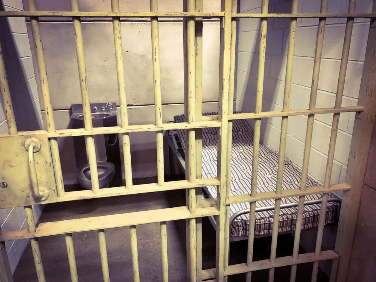 Jail Cell With Single Bed Background