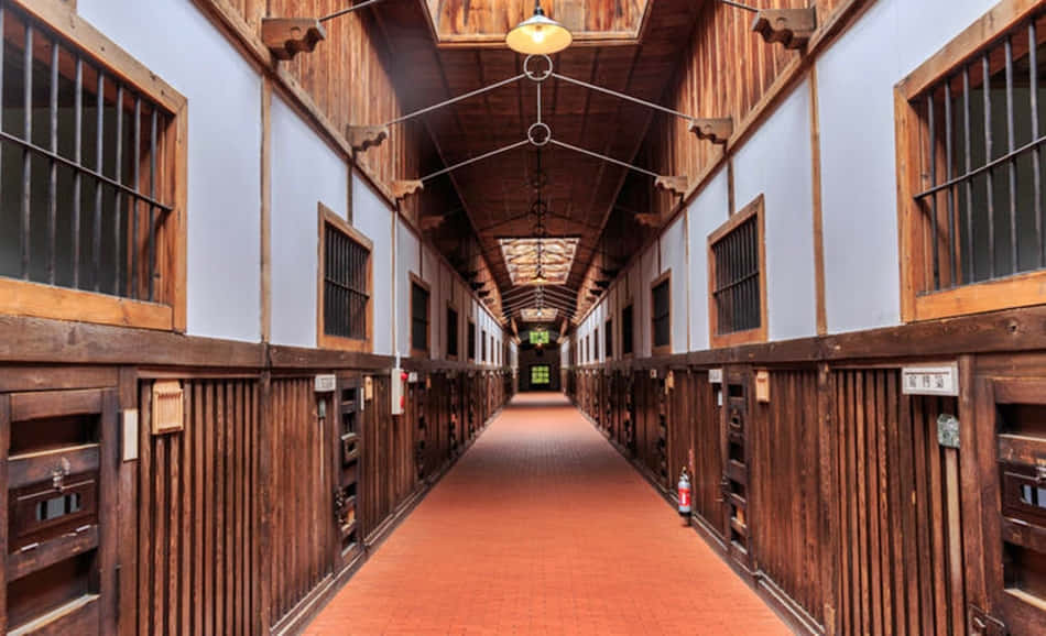 A Hallway With Wooden Walls And Wooden Doors