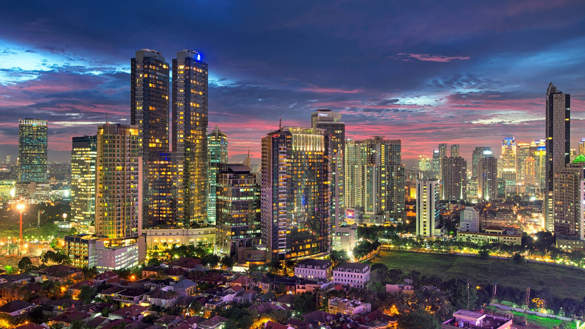 Vibrant Jakarta City Skyline Amidst Bustling Establishments Wallpaper