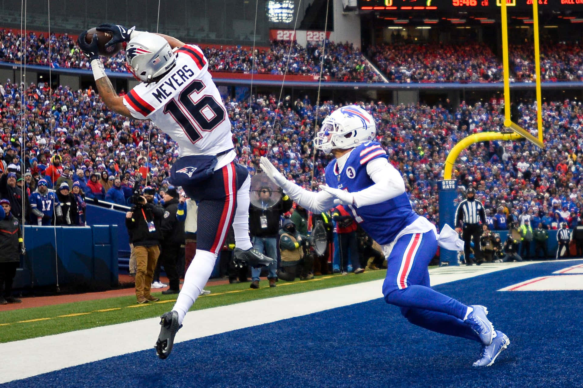 Download Jakobi Meyers Mid Air Catch Wallpaper | Wallpapers.com