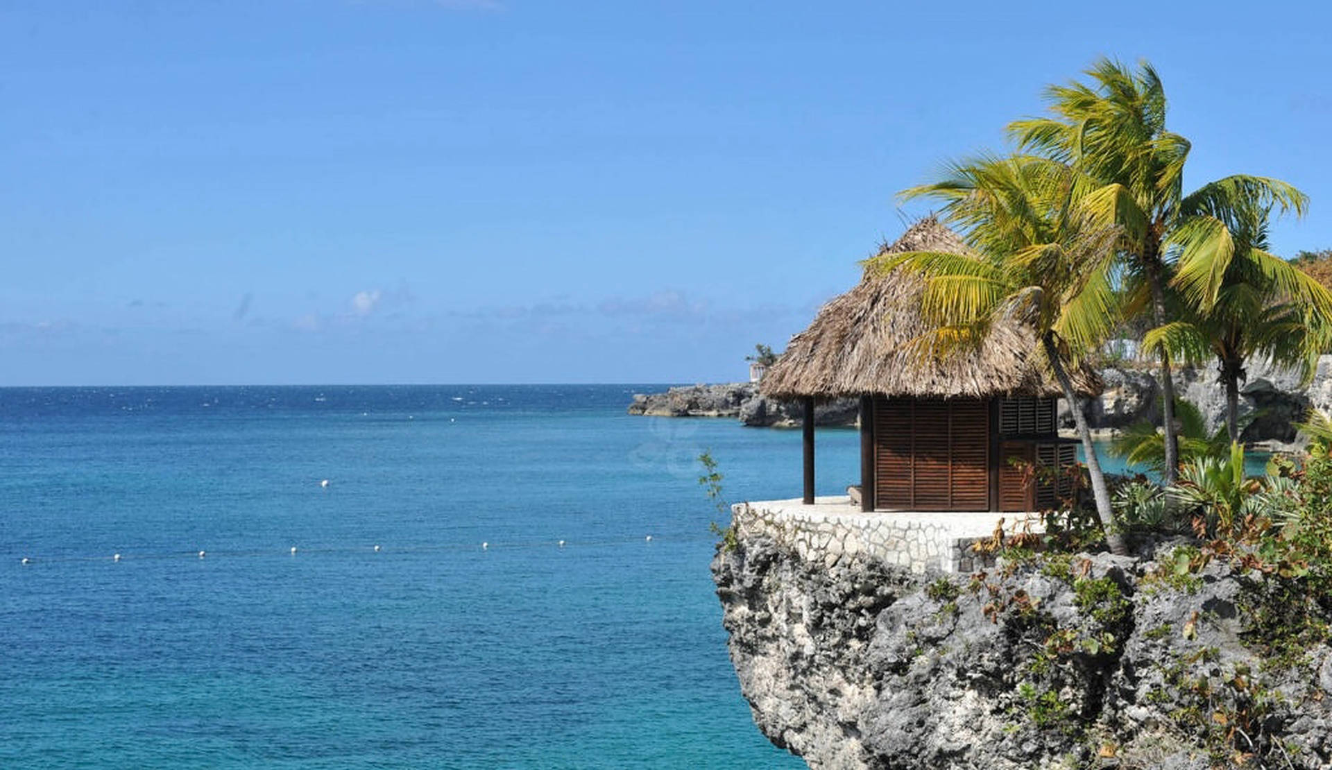 Jamaica Beach Cliff Hut tapetet: Udnyt den smukke udsigt over havet, sandstrand, solnedgang og klippehuler baggrunden Wallpaper