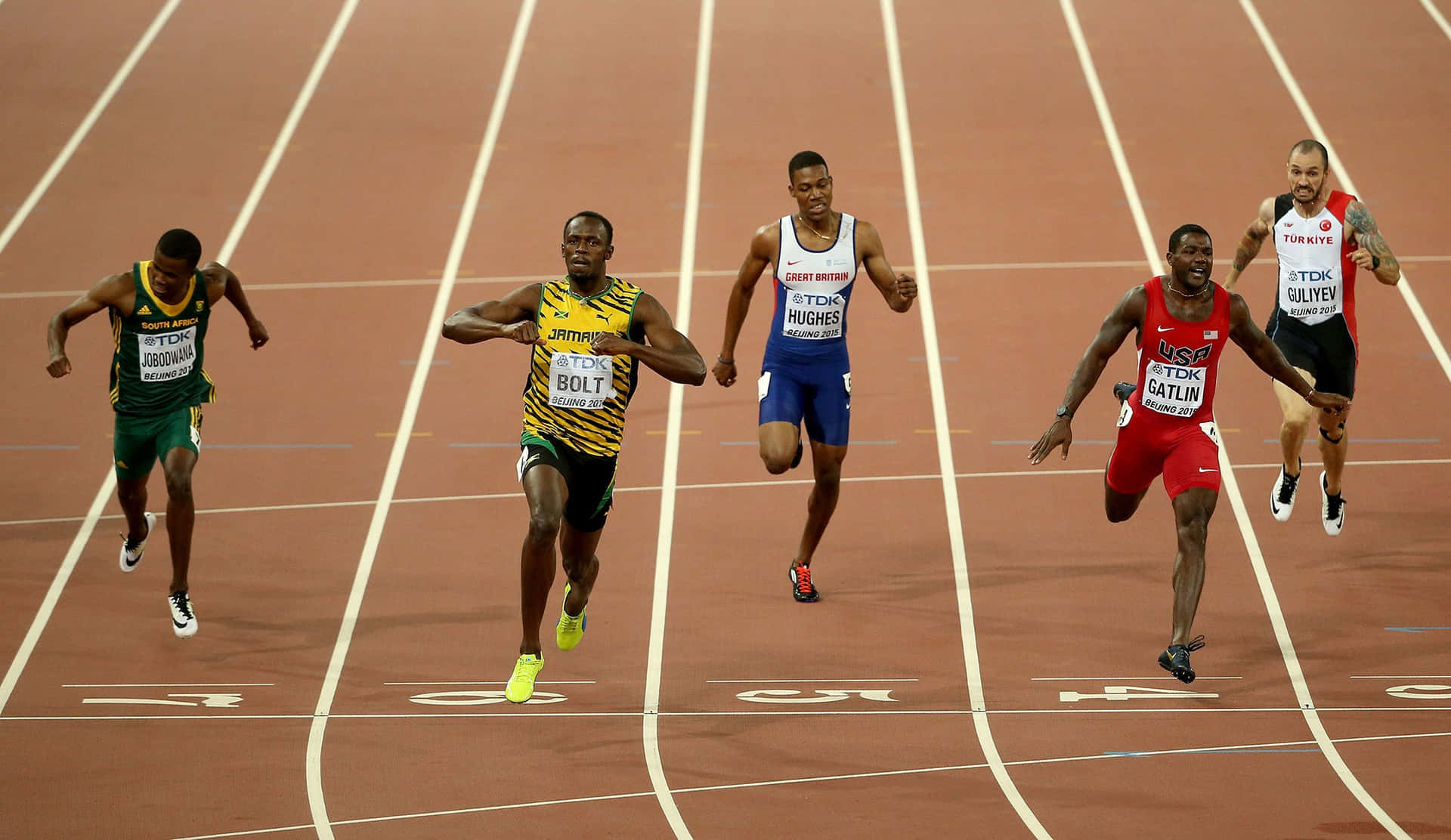 Atletajamaicano Usain Bolt Em Corrida. Papel de Parede