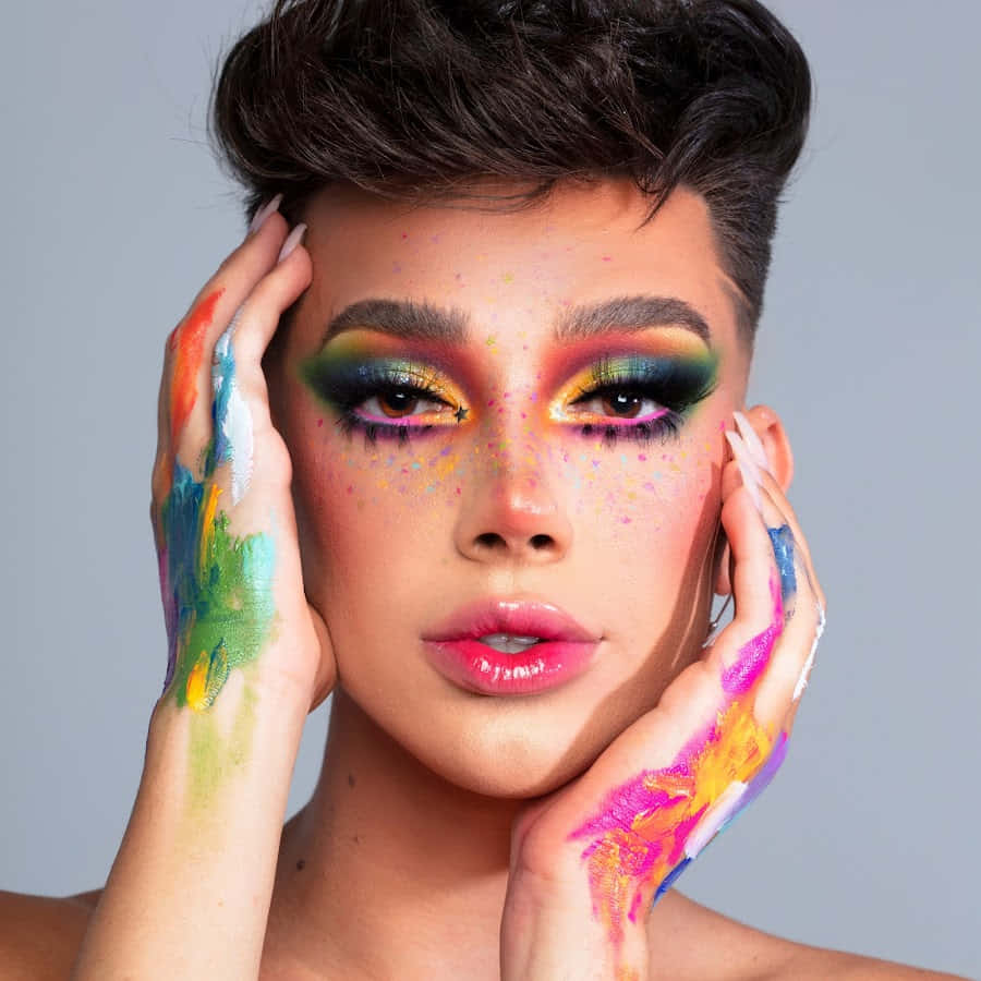 A Woman With Colorful Makeup And Hand Painted Hands Wallpaper