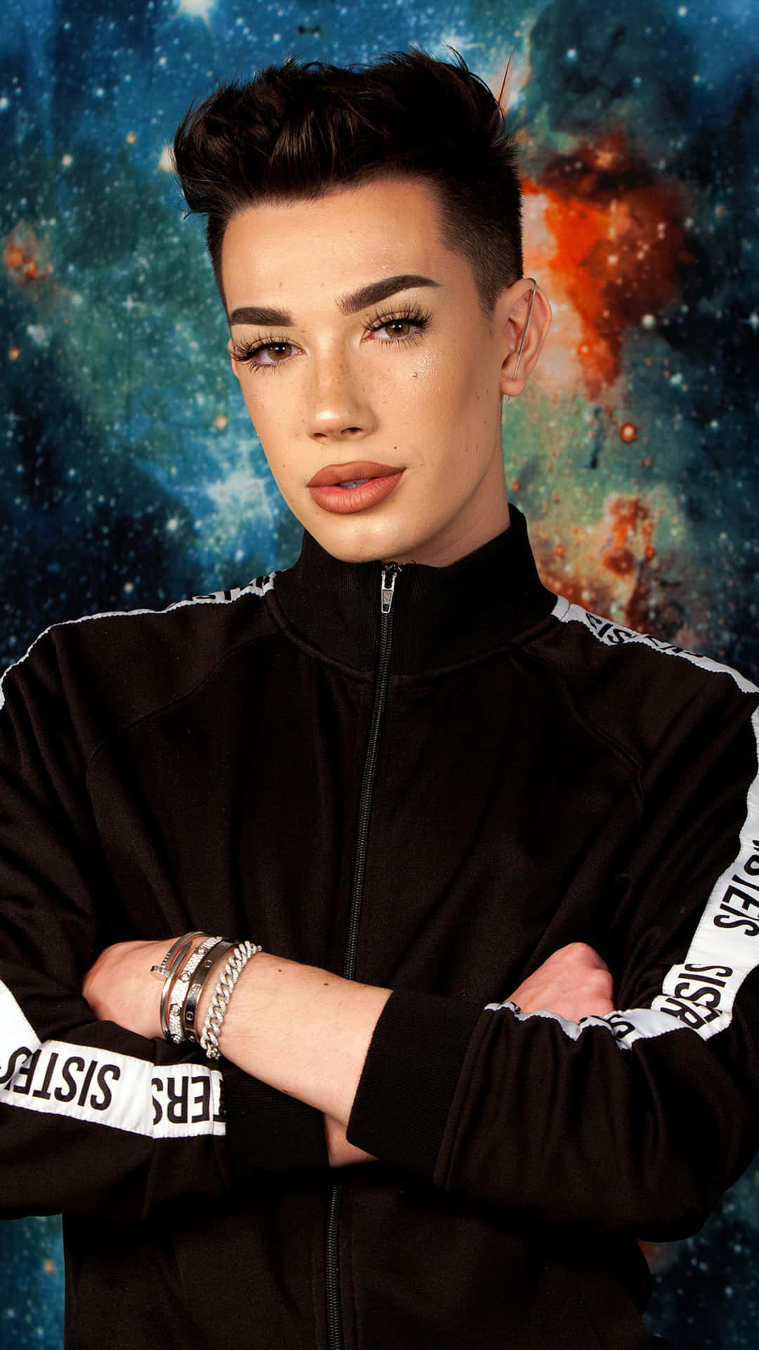 A Young Man In A Black Jacket Standing In Front Of A Space Background Wallpaper