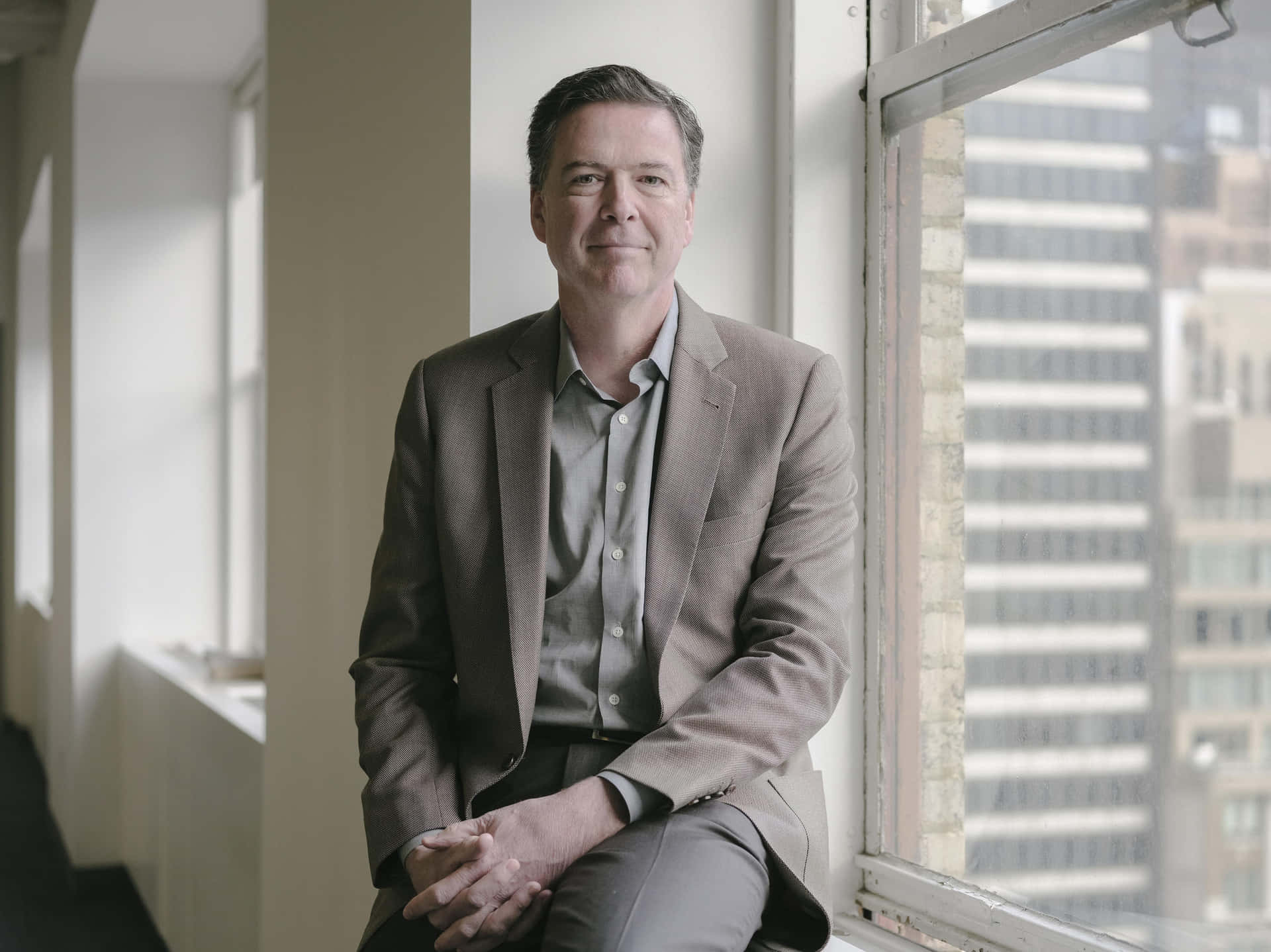 James Comey Sitting Near Window Wallpaper