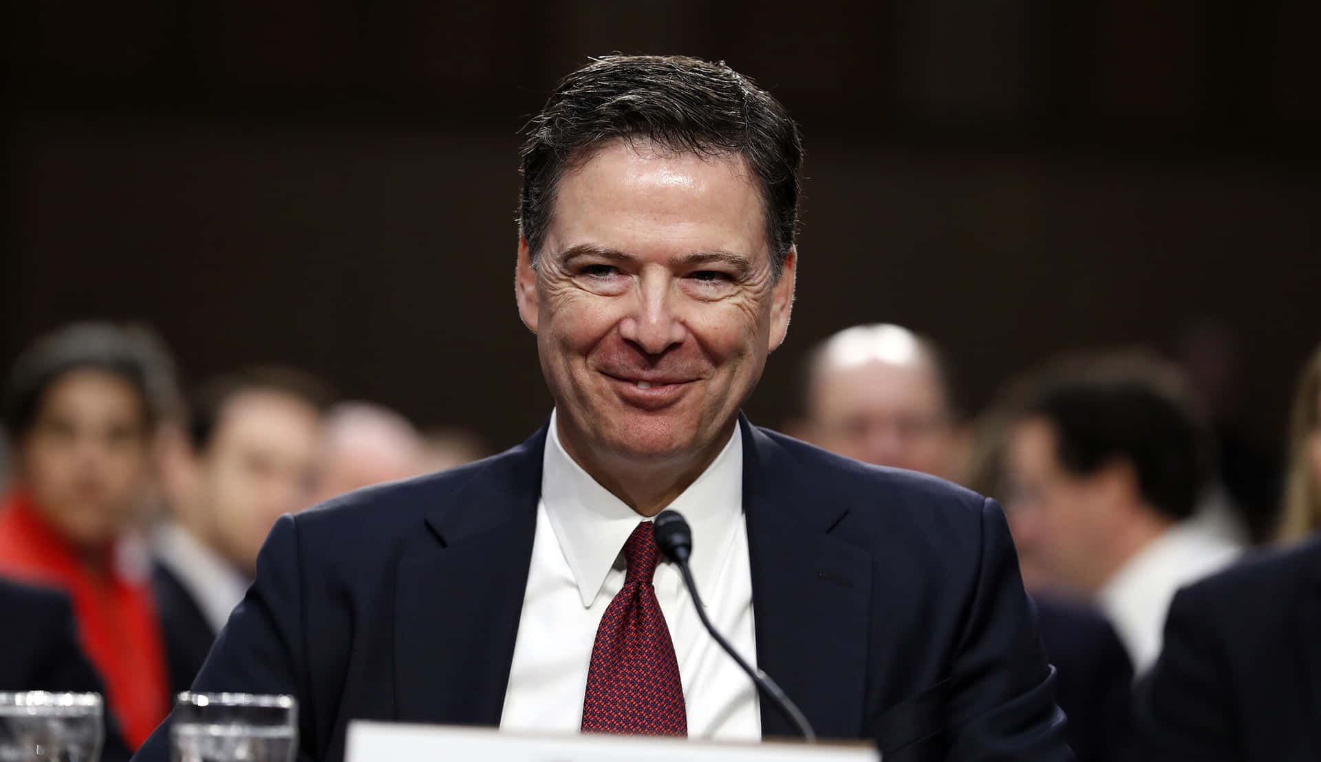 Download James Comey Smiling During Hearing.jpg Wallpaper | Wallpapers.com