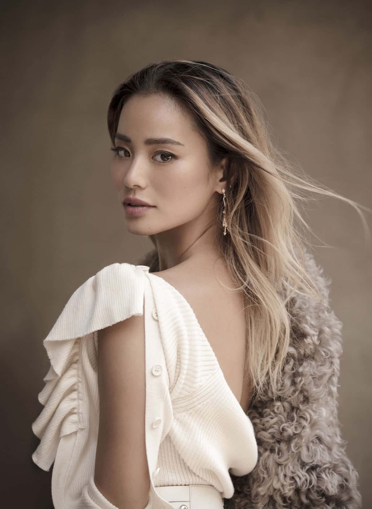 Jamie Chung posing gracefully in a stylish outfit Wallpaper