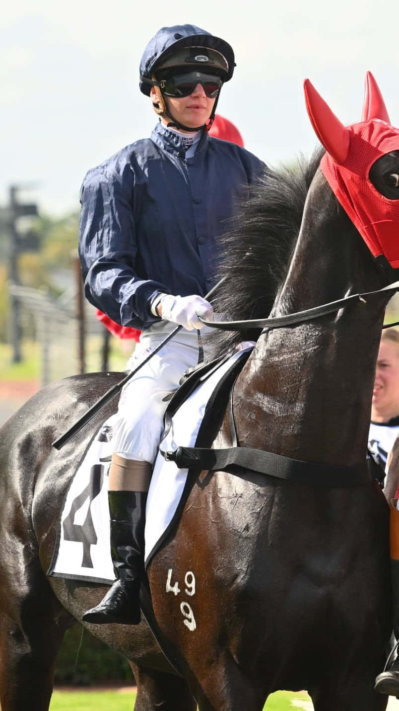 Jockey Jamie Kah in action on the racecourse Wallpaper