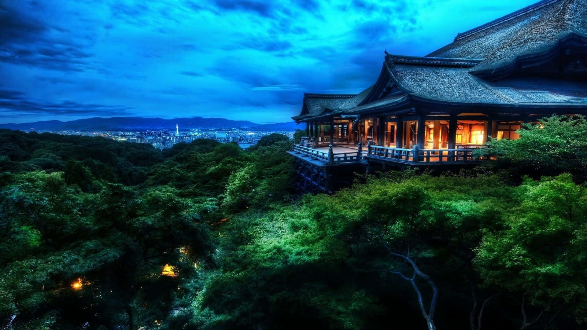 A Japanese Temple Lit Up At Night Wallpaper