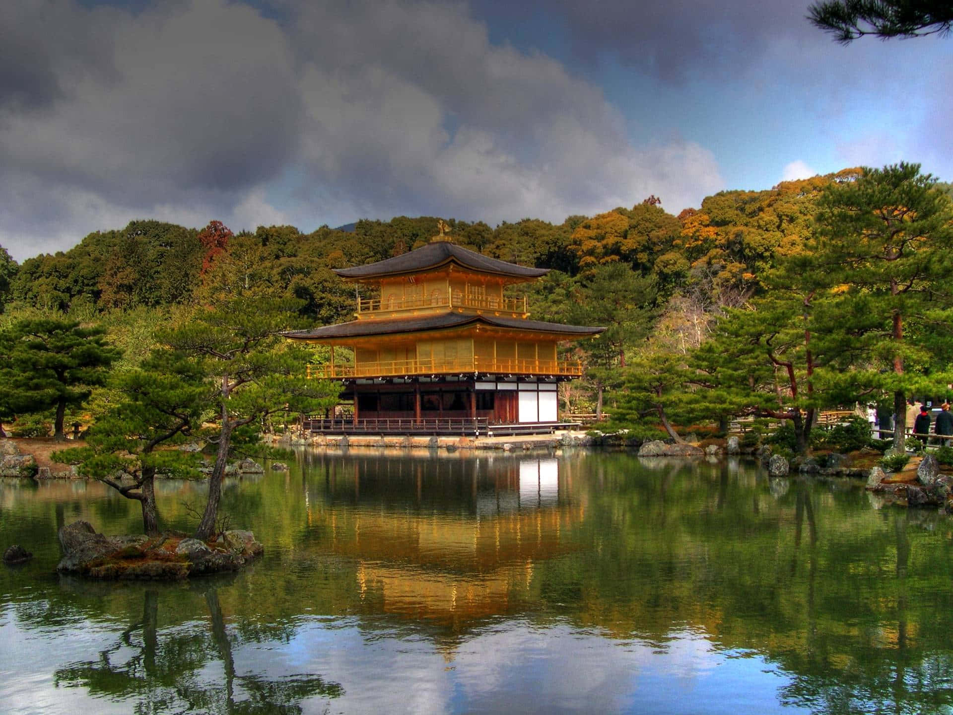 Traditional Japanese buildings against a breathtaking mountain backdrop