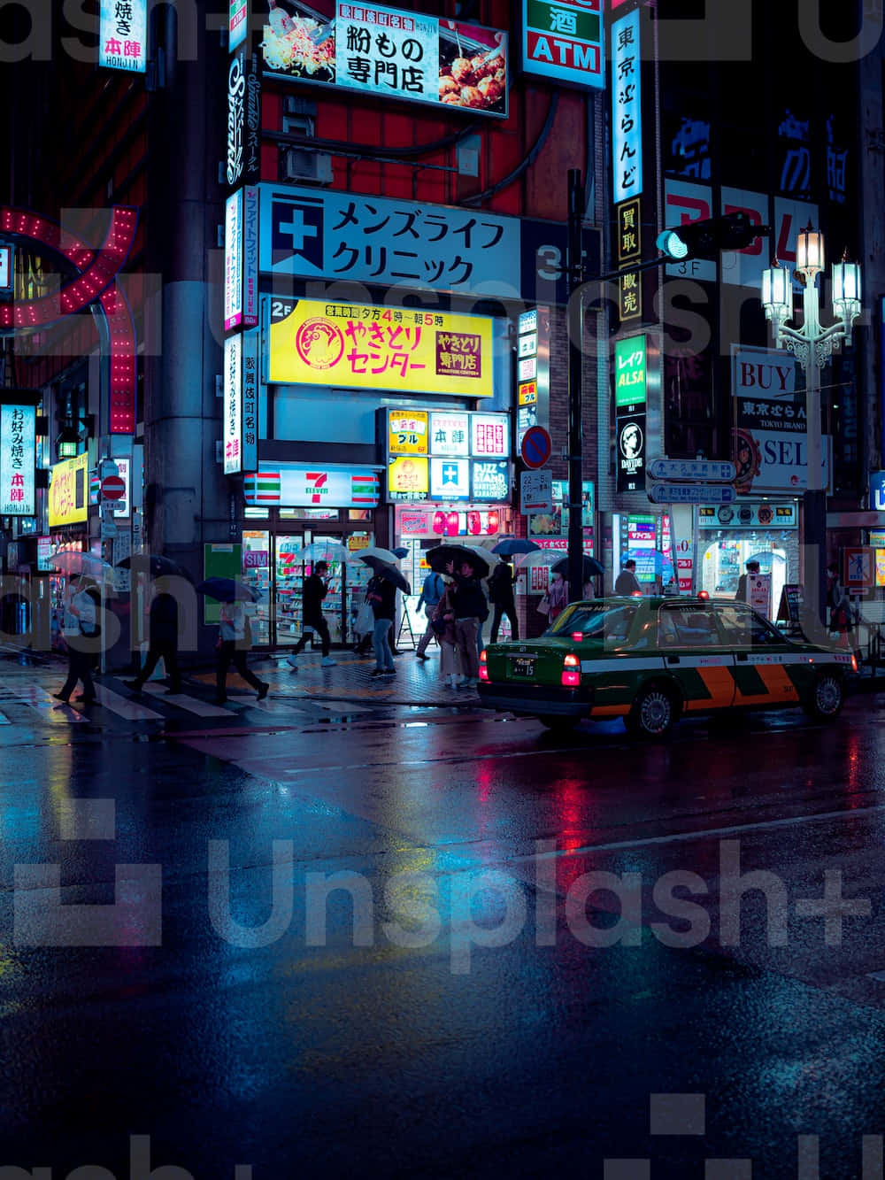 A City Street At Night With Many Signs Wallpaper