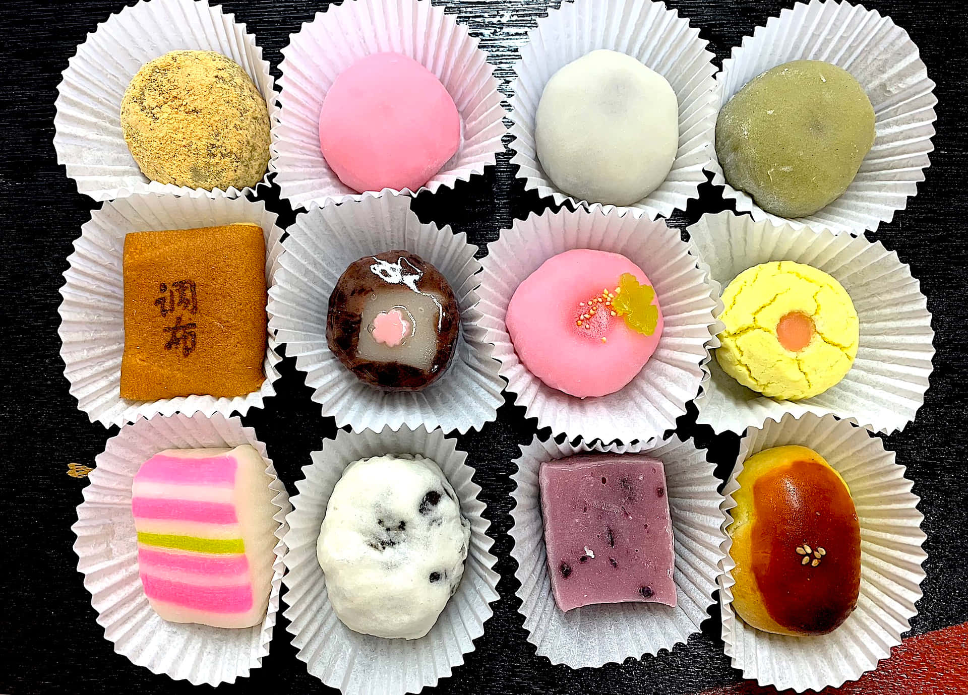 Assorted Japanese Sweets on a Wooden Table Wallpaper