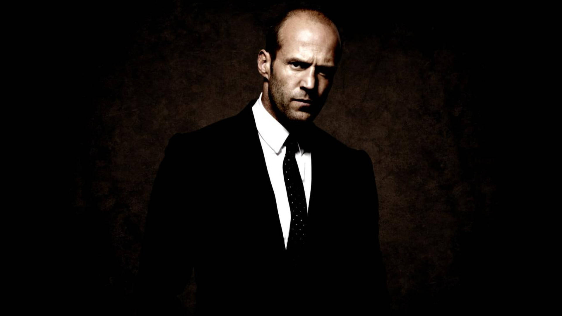Jason Statham In Black Suit Background