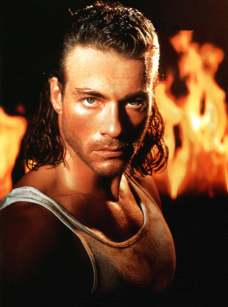 Hollywood icon Jean-Claude Van Damme showcasing his timeless charisma. Wallpaper