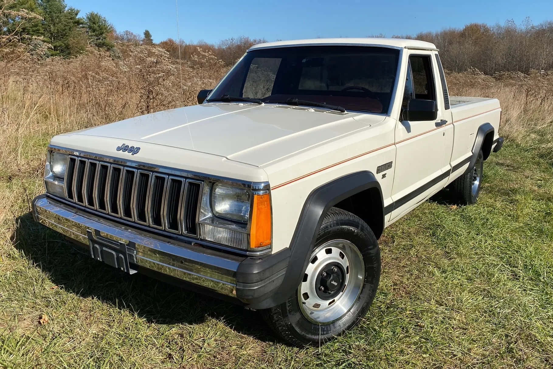 A rugged Jeep Comanche on an off-road adventure Wallpaper