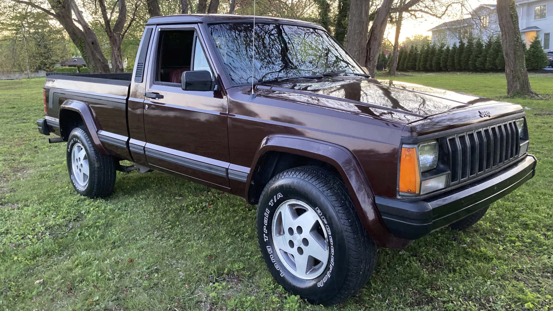 Jeep Comanche cruising on a picturesque terrain Wallpaper