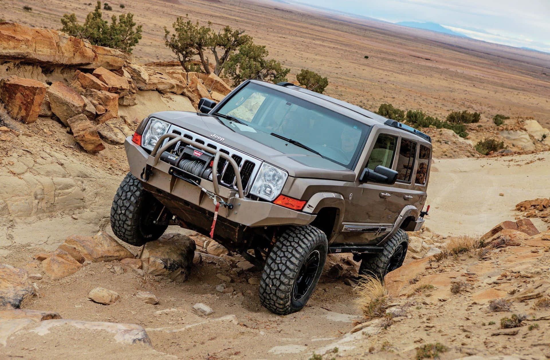 Majestic Jeep Commander conquering rugged terrain Wallpaper